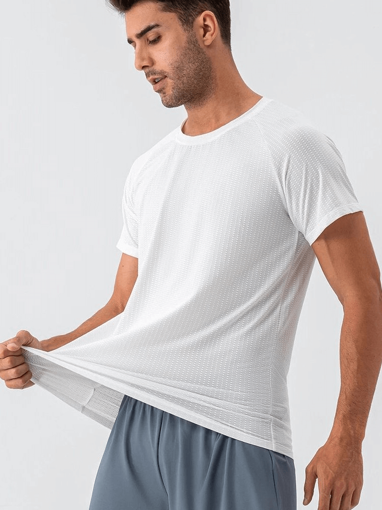 Model wearing white quick-drying mesh sports men's T-shirt for training, SF1725, showing fabric stretch and breathability.