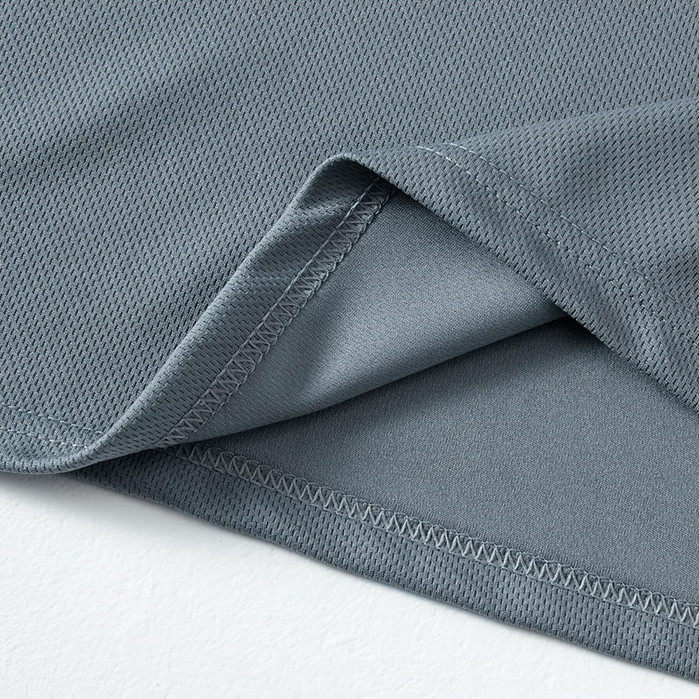Close-up of gray quick-drying fabric from a performance short-sleeved T-shirt, showcasing moisture-wicking material and stitching detail.