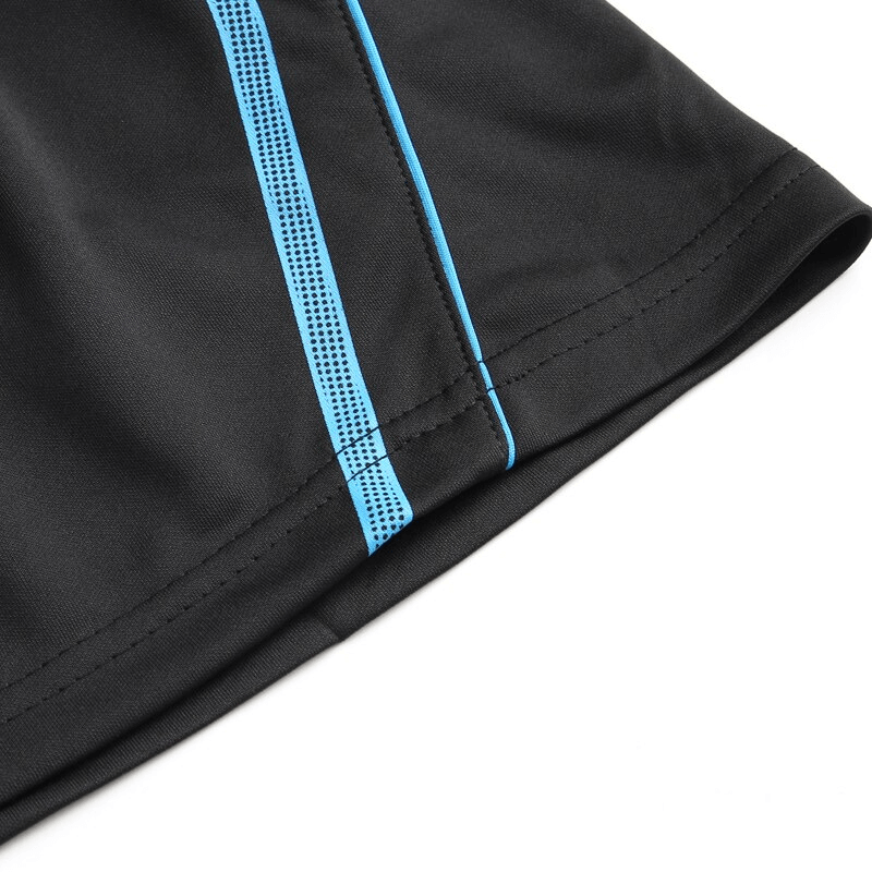 Close-up of black quick-drying sports men's shorts with blue side stripe details, showcasing lightweight fabric and stitching.