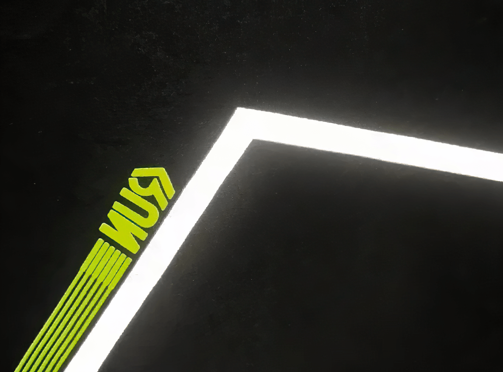 Abstract black and white geometric shape with a hint of neon green design element.