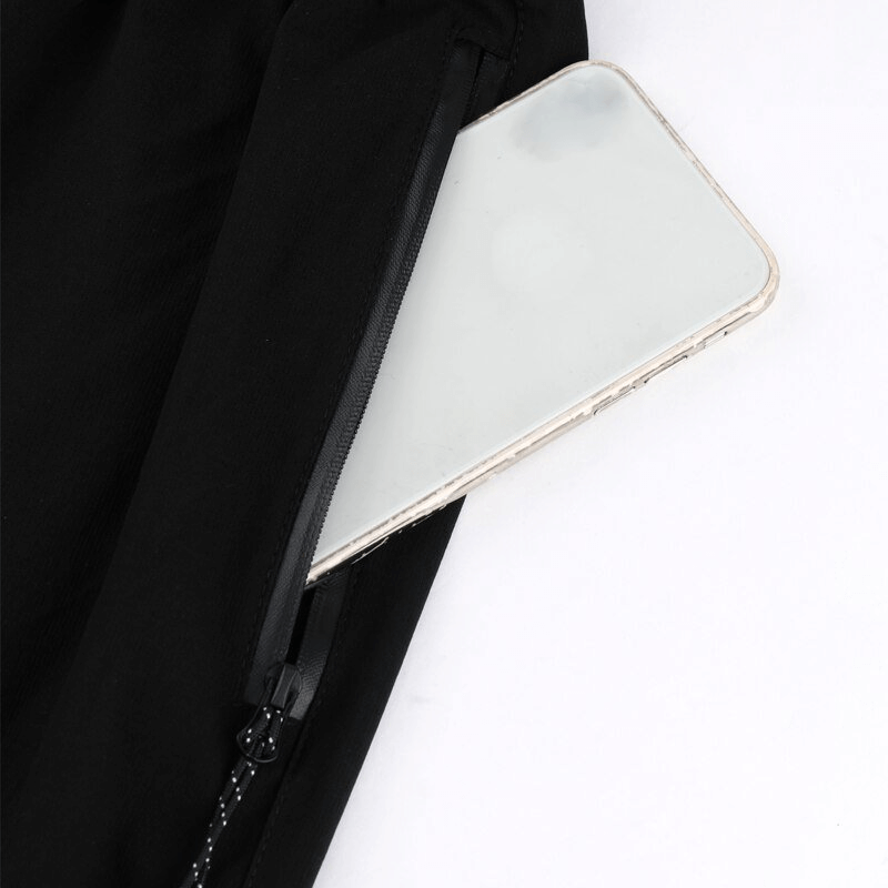 Close-up of a phone in the side pocket of quick-drying sports pants, showcasing the practical and secure storage feature.