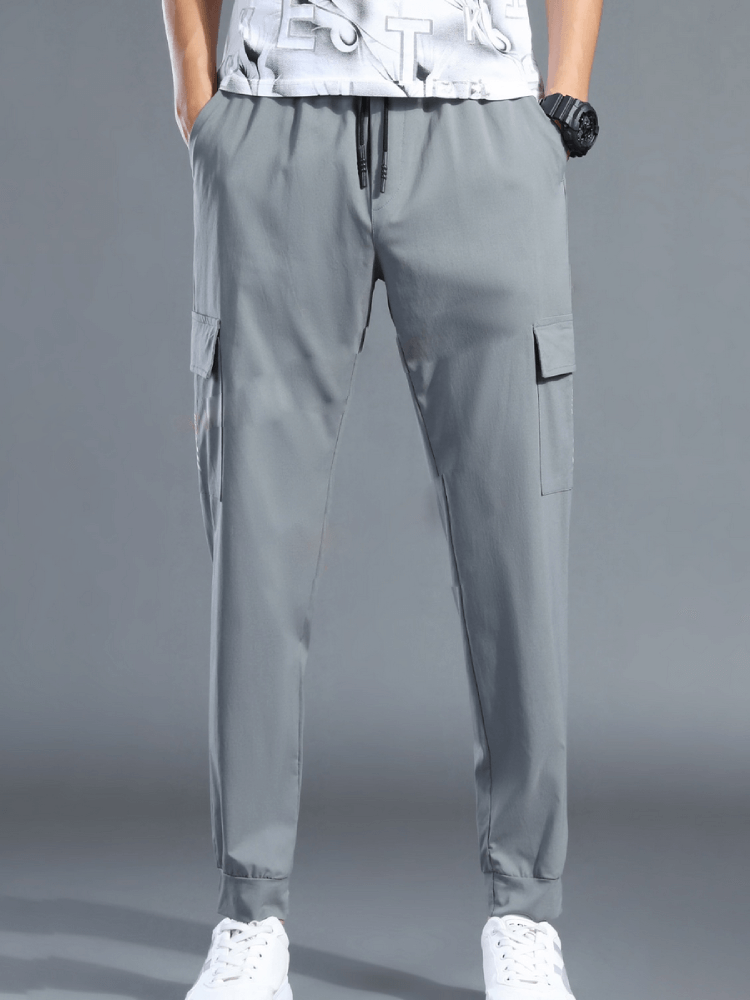 Men's quick-drying sports pants with elastic waistband and side pockets, perfect for running and workouts.