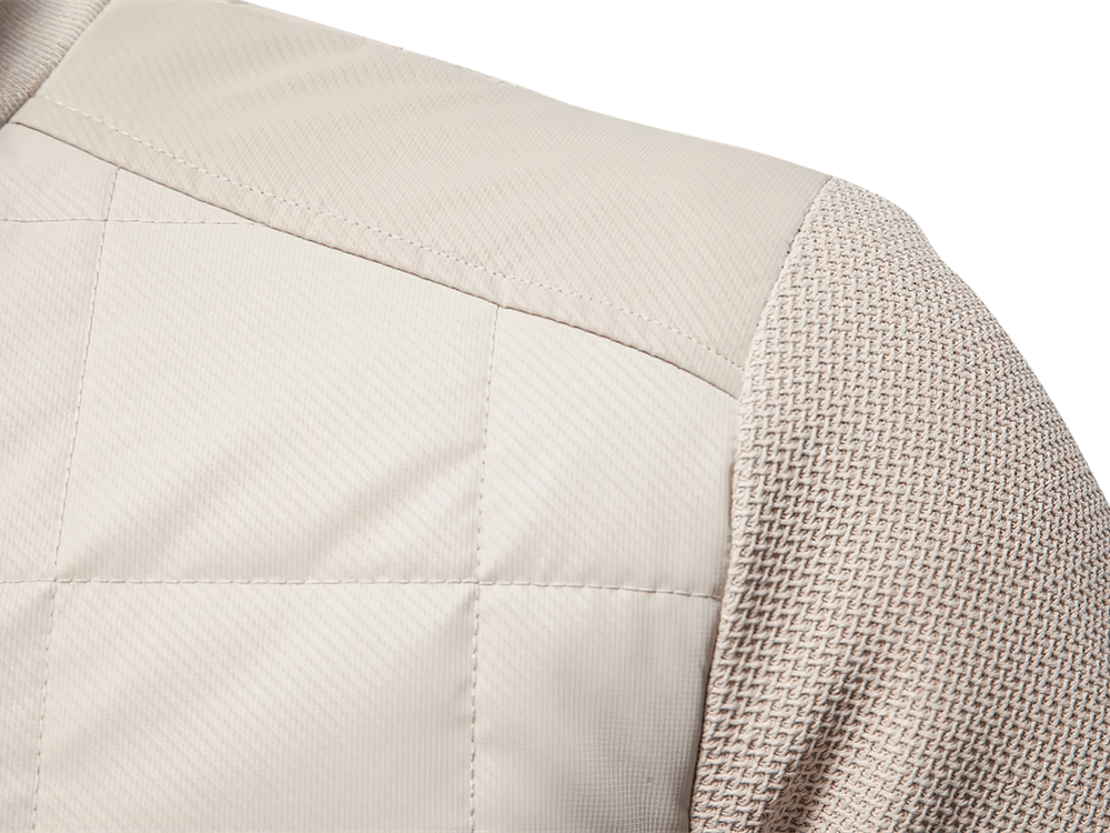 Close-up of beige quilted jacket with textured sleeves, showing detailed design and fabric quality, perfect for men's fashion.