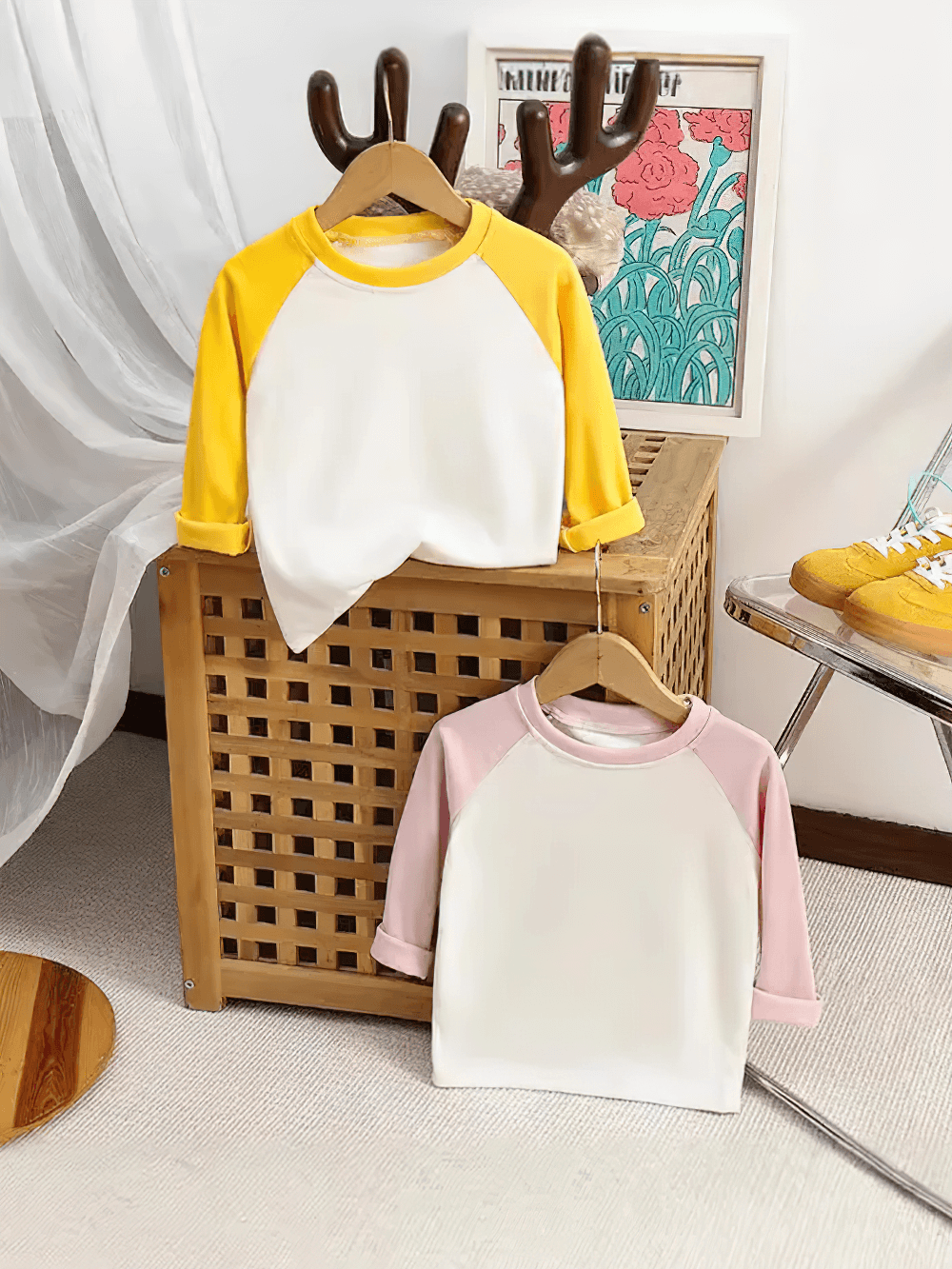 Adorable kids' tops with raglan sleeves in pink and yellow, perfect for a cute and comfy style. Ideal for little fashionistas.