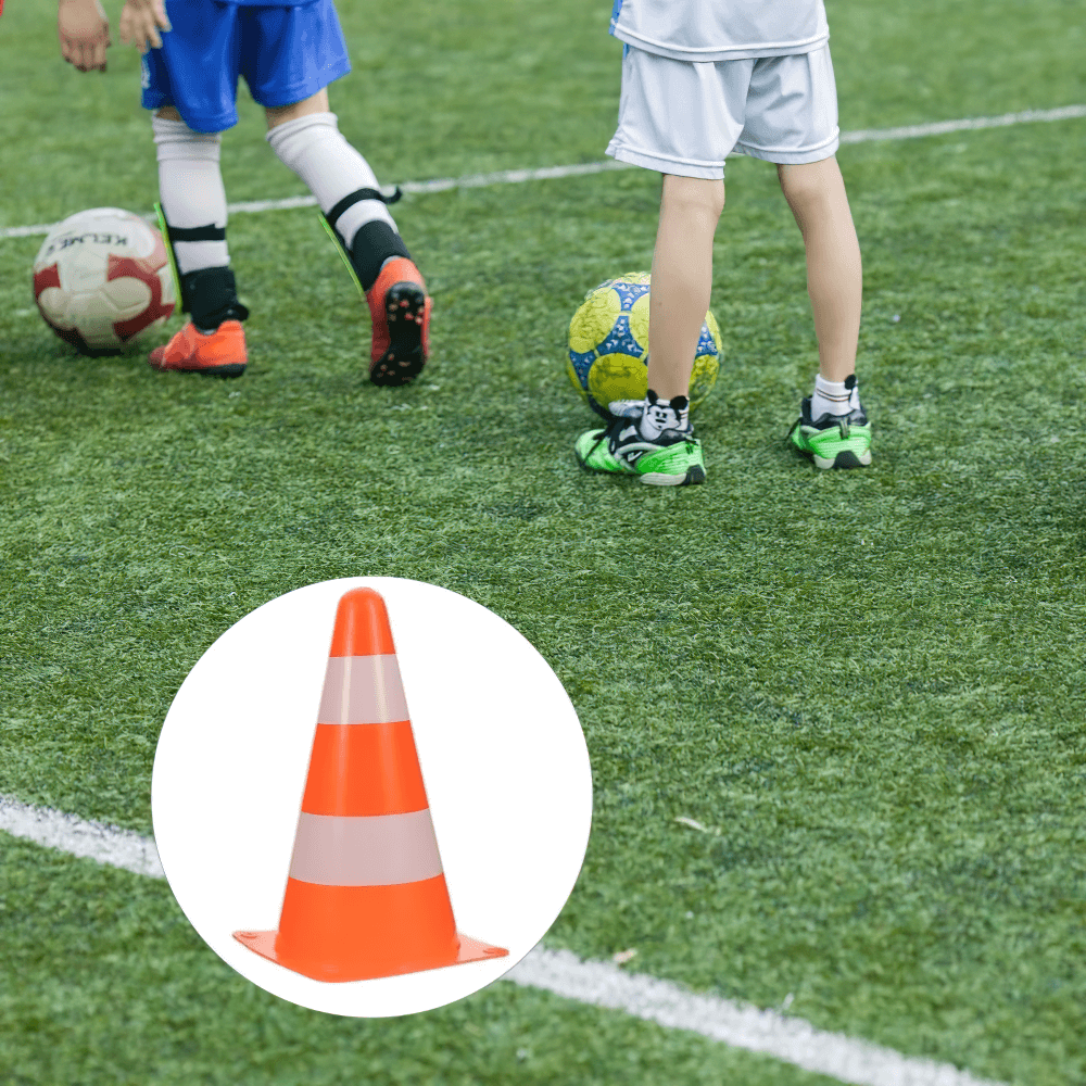 Kids playing football with a reflective training cone, ideal for marking boundaries and drills, 23cm bright orange with reflective bands.