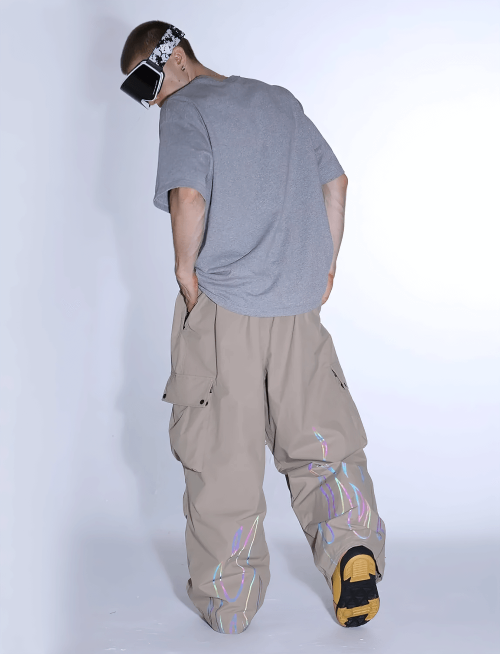 Back view of a man wearing loose fit Reflective Flame Waterproof Snowboard Pants - SF4265 showing reflective flame patterns.