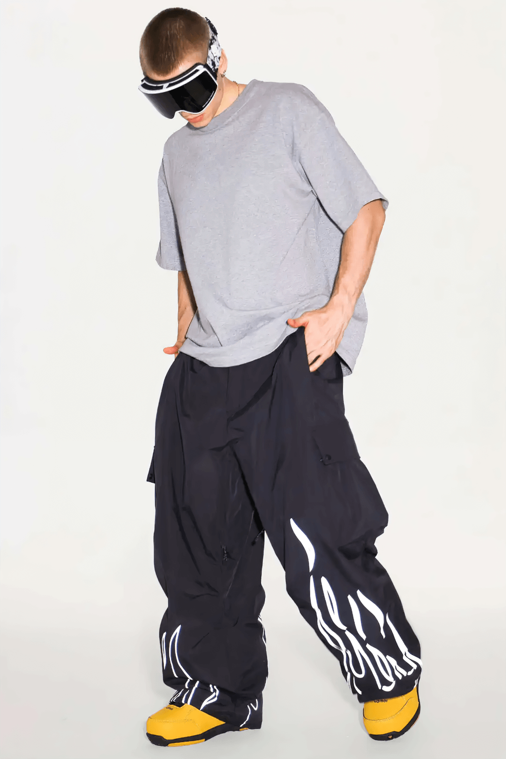 Man wearing Reflective Flame Waterproof Snowboard Pants - SF4265 with a loose fit and flame design, ideal for snowboarding.