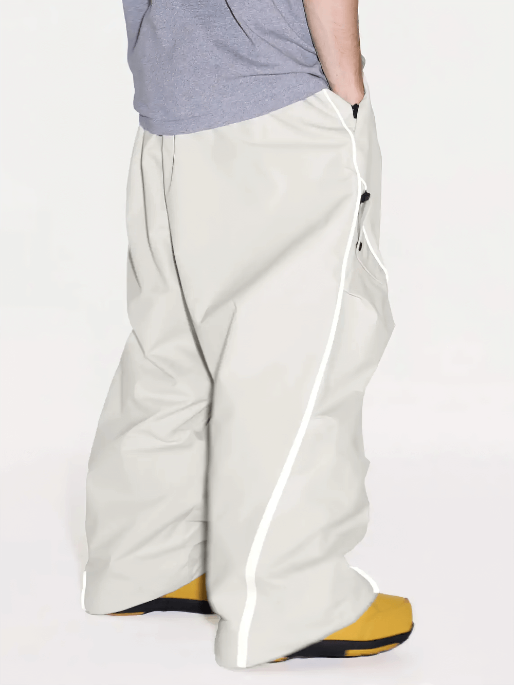 Side view of Reflective Stripe Baggy Snowboard Ski Pants - SF4247 with white stripes and loose fit, paired with yellow boots.