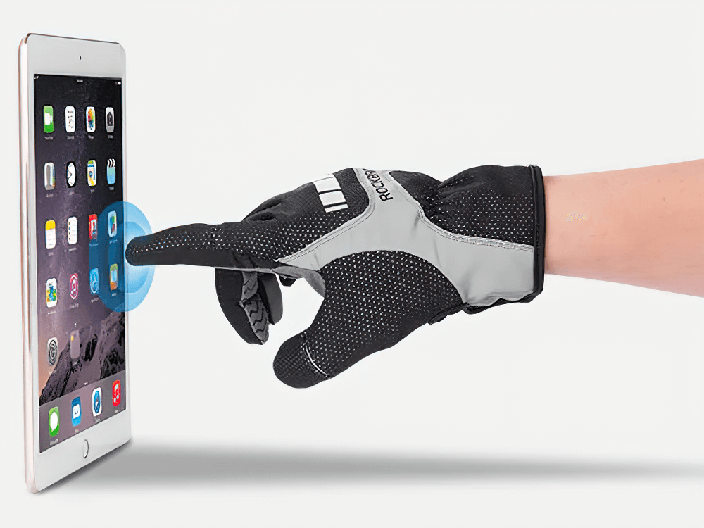 Reflective touchscreen cycling gloves with SBR pad in use on a tablet; ideal for keeping warm and visible during winter cycling.