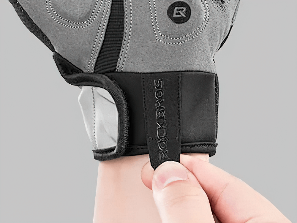 Person adjusting reflective touchscreen cycling gloves with SBR padding for winter.