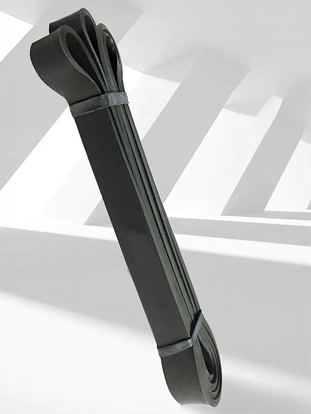 Black heavy duty resistance band for pull ups and stretching, perfect for home workouts and strength training.