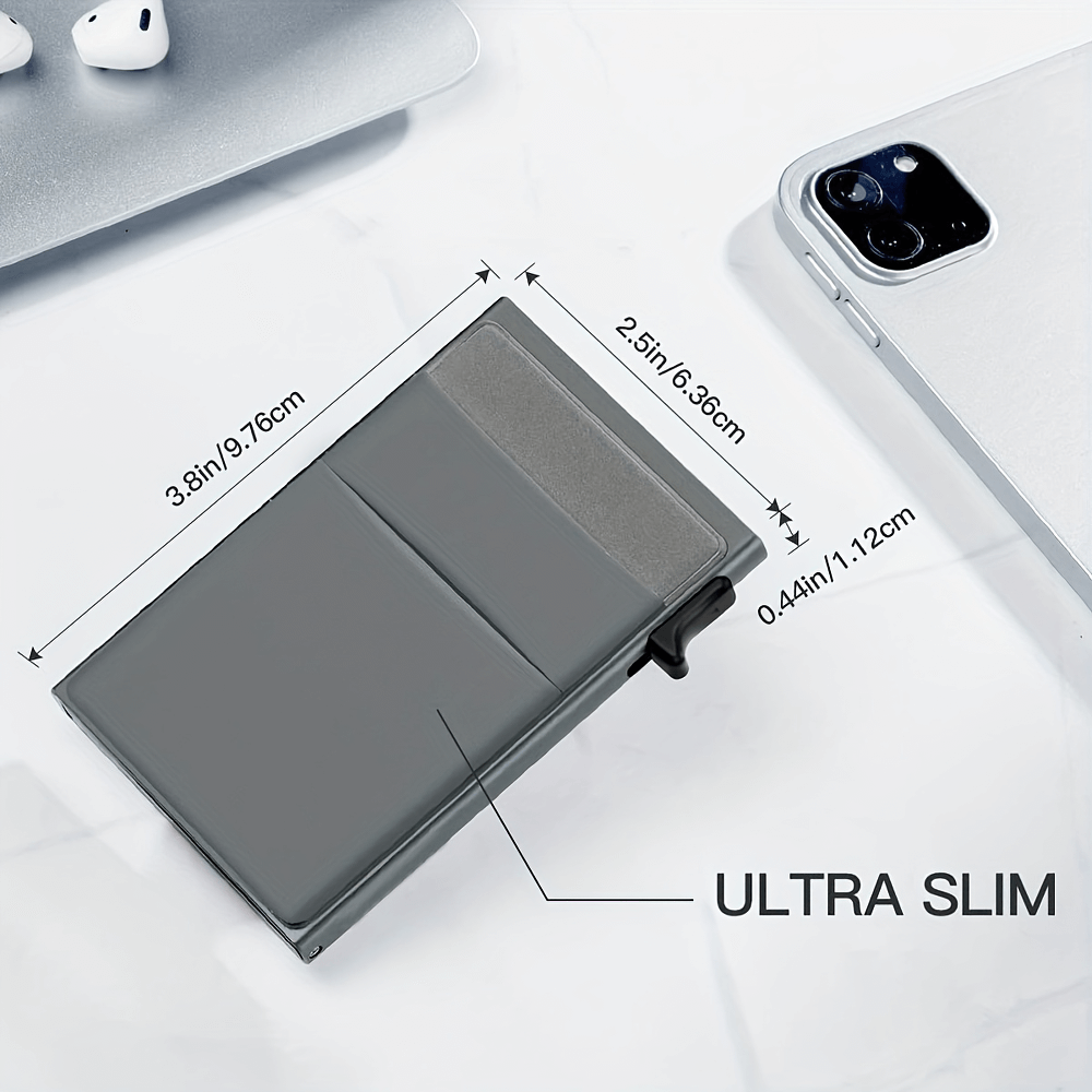 Ultra slim RFID blocking aluminum card case with measurements, shown alongside smartphone and earbuds for size reference.