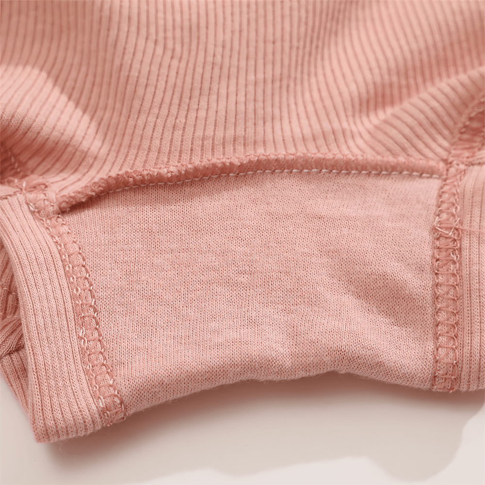 Close-up of pink ribbed boyshort panties with soft stretchy fabric and secure elastic waistband.