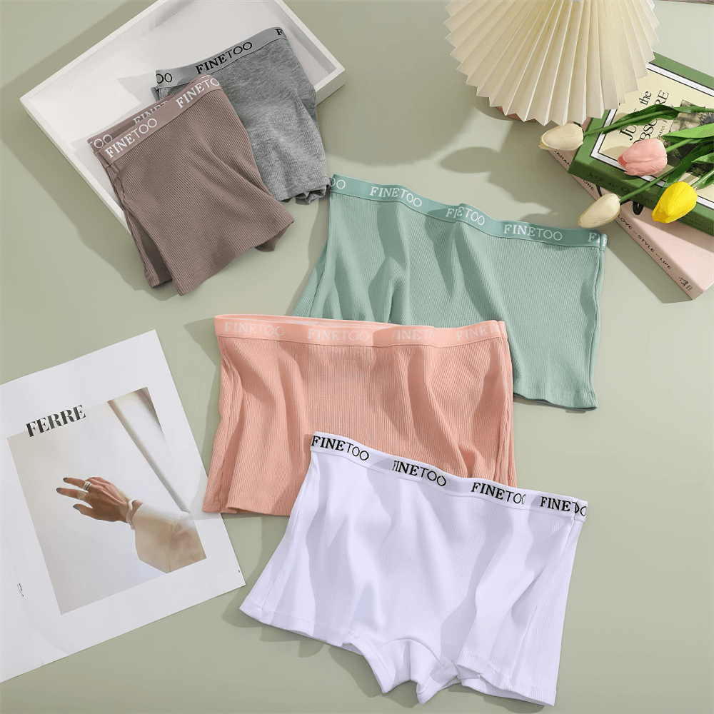 Colorful ribbed boyshort panties with elastic waistbands laid out on display, showcasing soft stretchy fabric and full coverage.