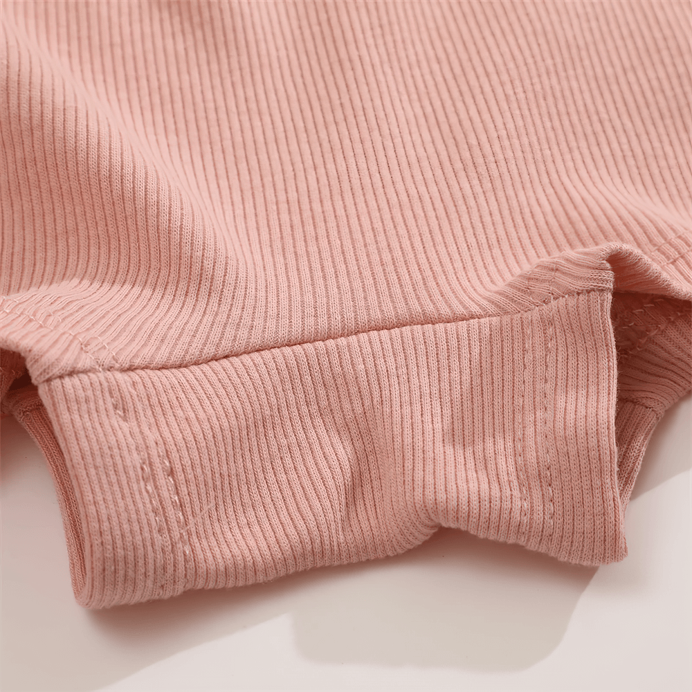 Close-up of ribbed pink boyshort panties with elastic waistband, showcasing soft, stretchy fabric for comfortable everyday wear.