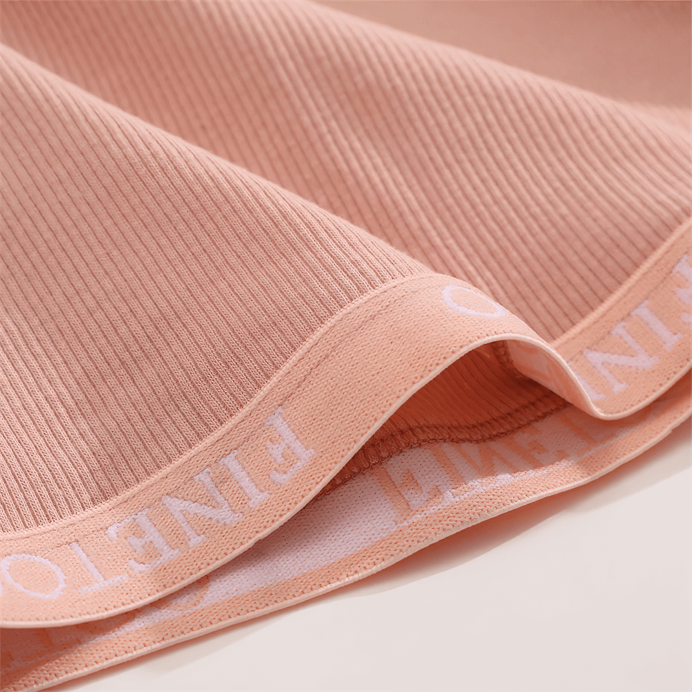 Close-up of ribbed boyshort panties with elastic waistband in peach, offering full coverage, comfort, and a sleek silhouette for daily wear.