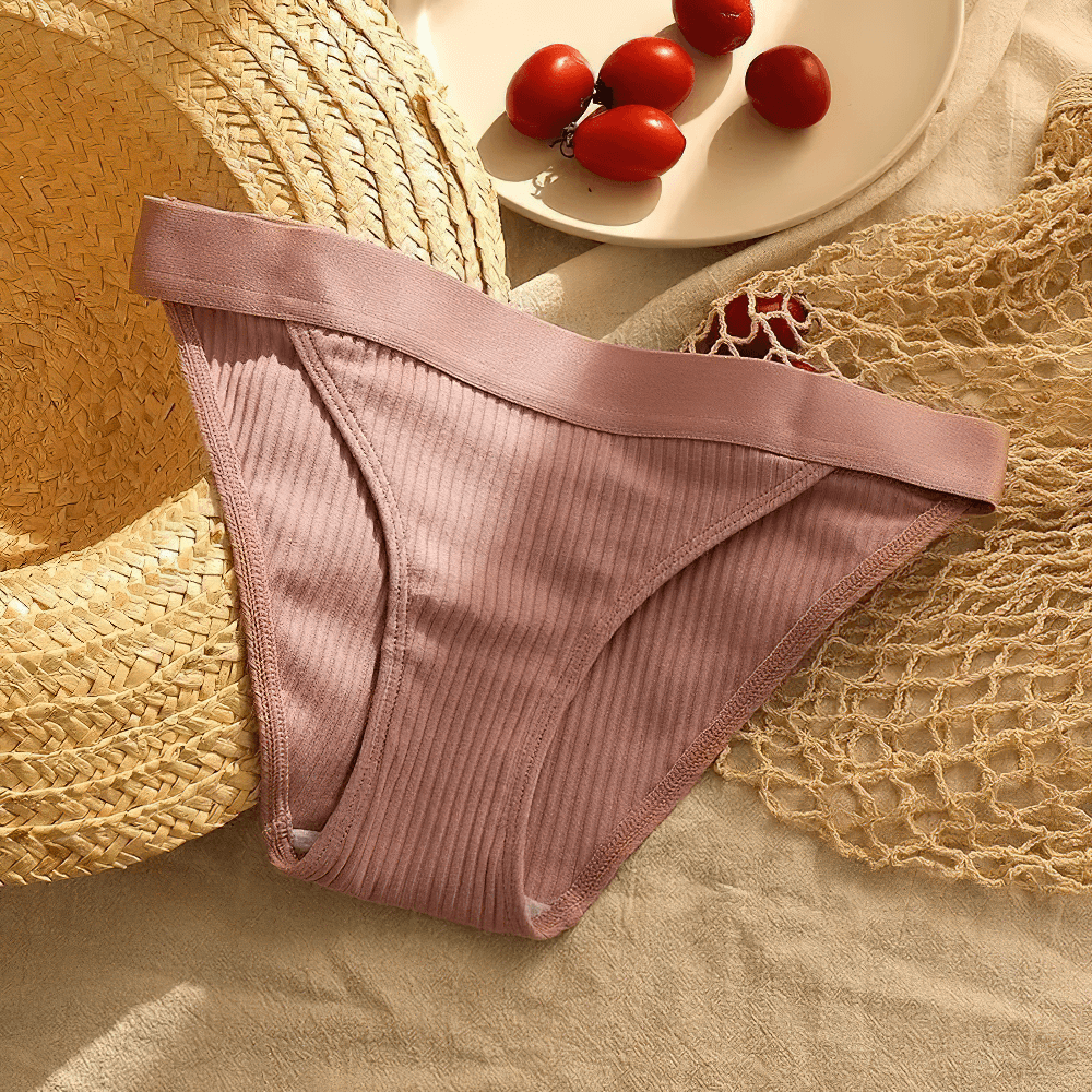 Ribbed Cotton Bikini Brief Panties for Women - SF4633 in soft pink resting on a natural fabric with accessories.