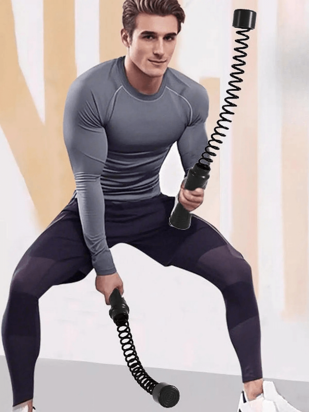 Man exercising with ropeless battle ropes for core strength and sports training at home gym.