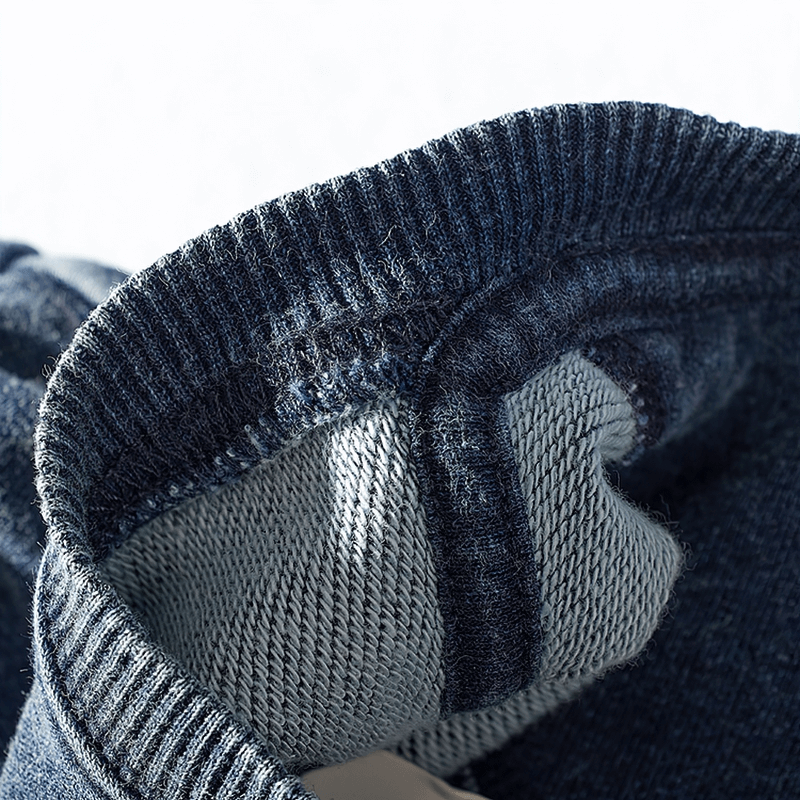 Close-up of knitted blue sports pullover fabric showing thick texture and craftsmanship.
