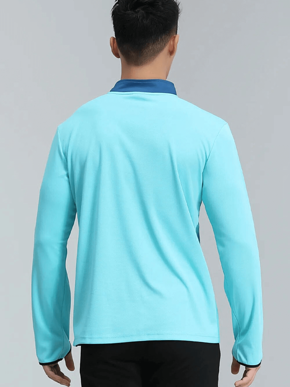 Back view of a blue running half zip top with stand collar and finger holes, perfect for comfort and mobility during workouts.