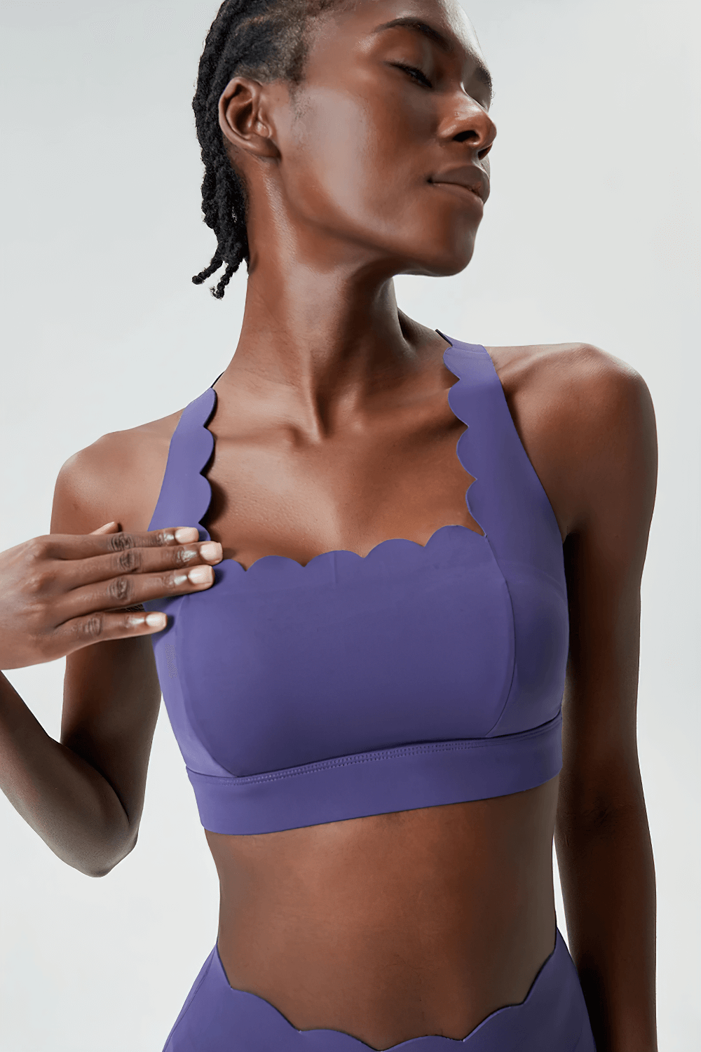 Model wearing purple Scallop Crossback Sports Bra with Removable Pads SF4000, showcasing wave neckline and crisscross back design.
