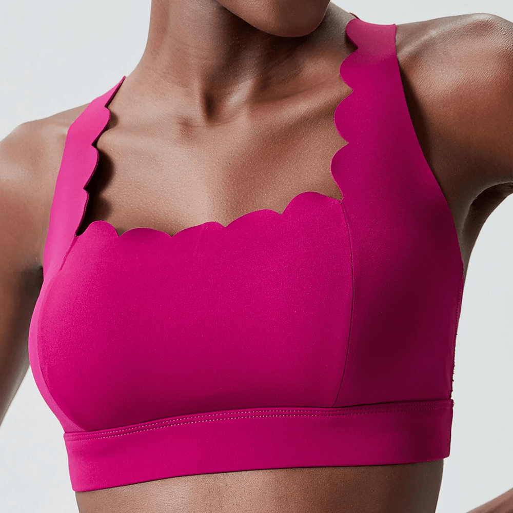 Bright pink Scallop Crossback Sports Bra with Removable Pads - SF4000, featuring wave neckline and scallop-edge design for women.