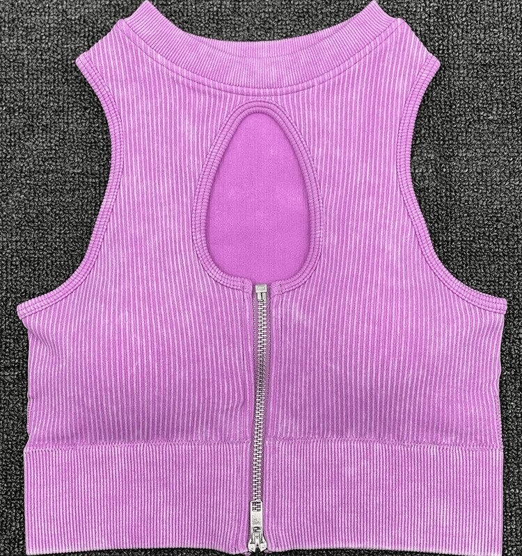 Purple seamless yoga zipper crop top, breathable nylon-spandex blend with stylish cutout back detail on gray background.