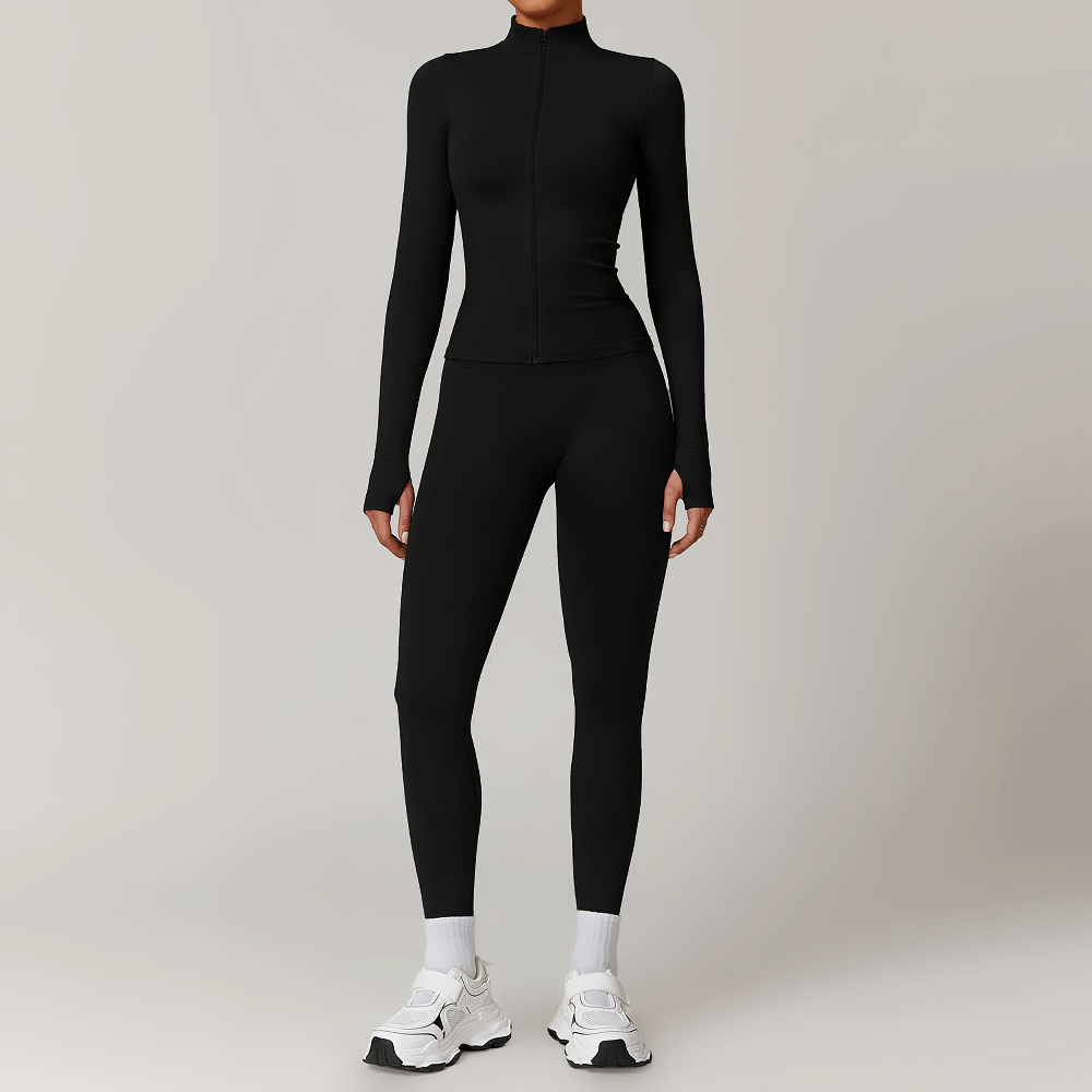 Woman wearing black seamless full-length activewear set with thumbholes, zip-up long sleeve top, and leggings, ideal for workouts or casual wear.