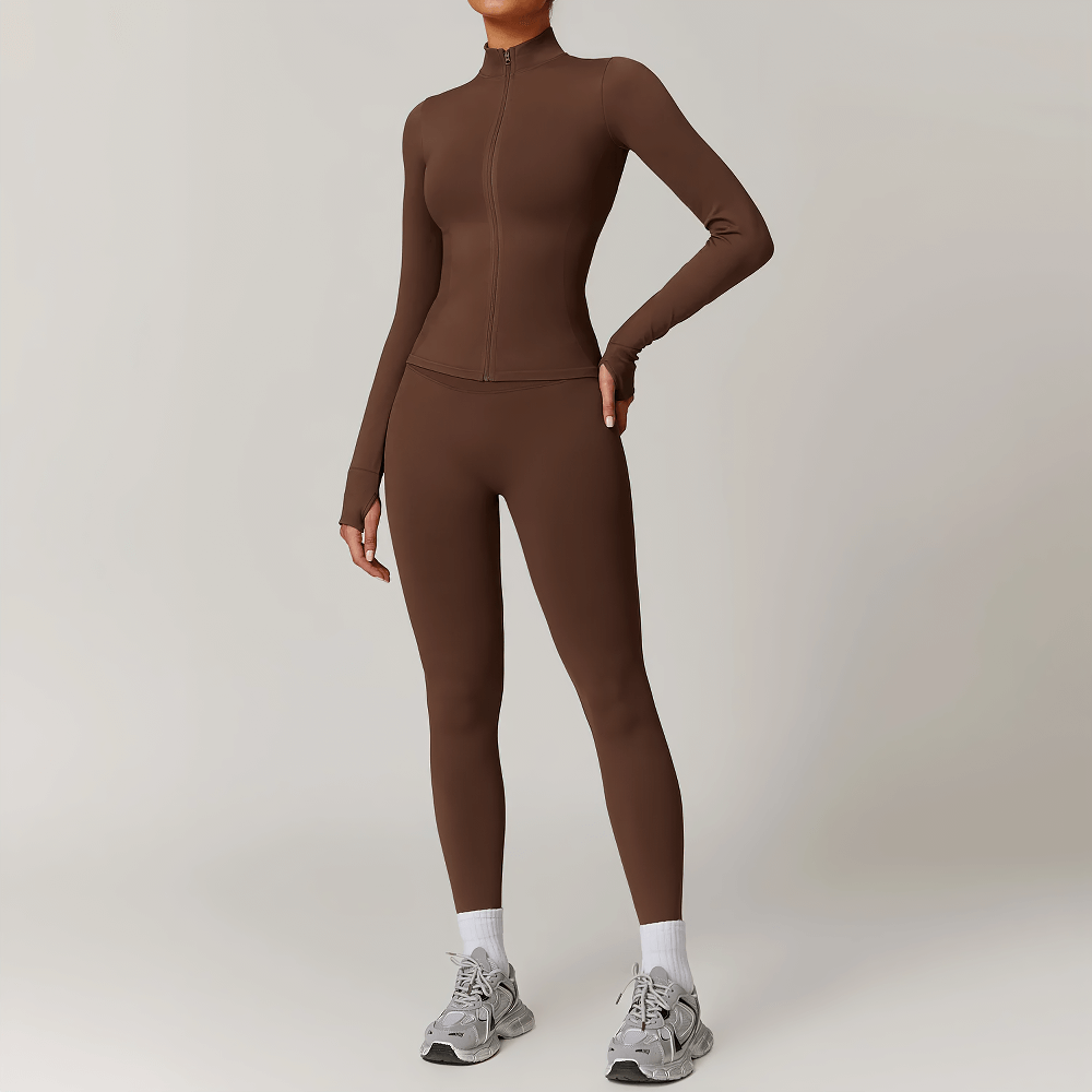 Woman wearing seamless brown full-length activewear set with zip-up top and thumbholes, perfect for workouts or casual wear.