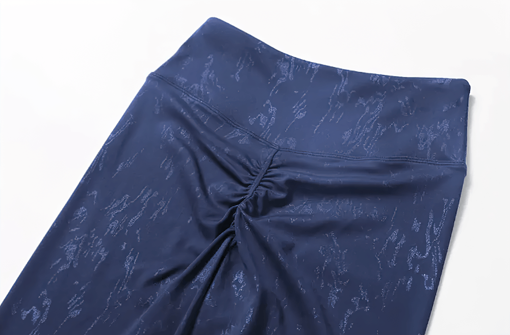 Navy blue high-waisted leggings with ruched detailing, perfect for stylish activewear and gym workouts.