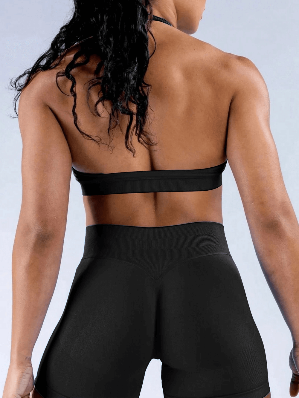 Model wearing Seamless Halter Neck Sports Bra with Padded Cups - SF4064 showcasing open back design for yoga, gym, and running.