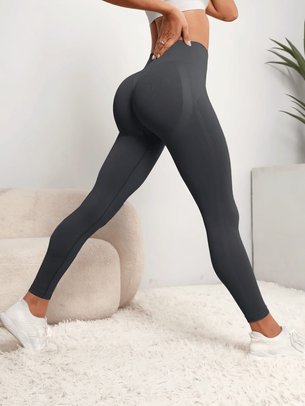 Woman wearing Seamless Hip-Lifting High Waist Fitness Leggings - SF4106 in a stylish workout pose highlighting the push-up design.