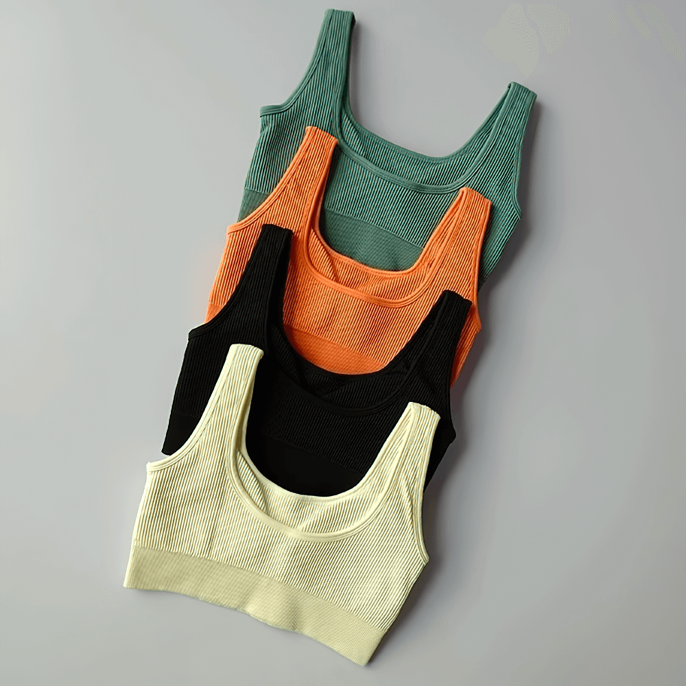 Colorful seamless ribbed sports bras for women, SF2186, stacked in green, orange, black, and cream shades, made from nylon and spandex.