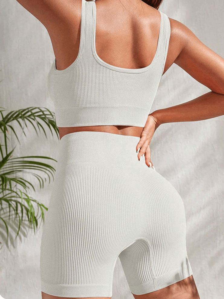 Woman wearing seamless ribbed yoga crop top and high waist shorts, showcasing a stylish athletic outfit. SF1759, quick-dry, breathable