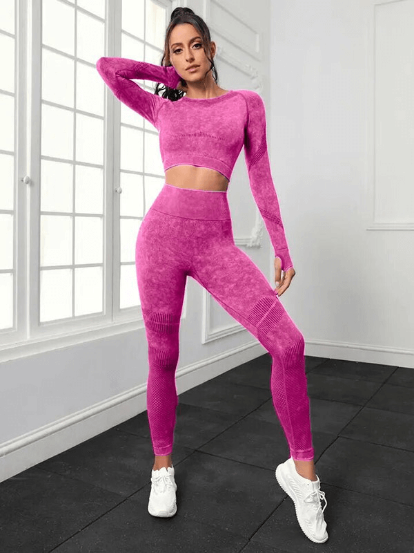 Woman modeling seamless high waist yoga set in pink, featuring a long sleeved top and pants, crafted from breathable eco-friendly fabric.