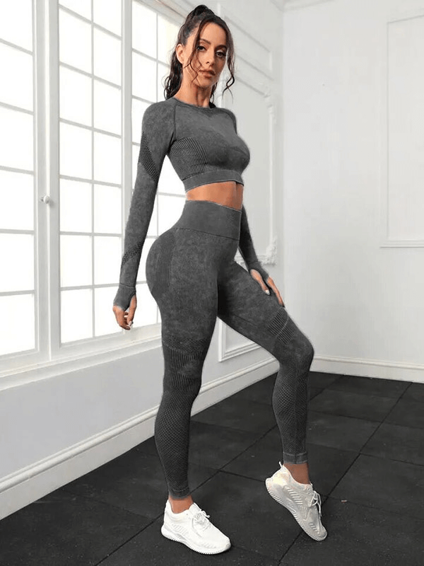 Woman wearing seamless high waist pants and long sleeved top in gray, perfect for yoga, showcasing eco-friendly, wrinkle-resistant fabric.