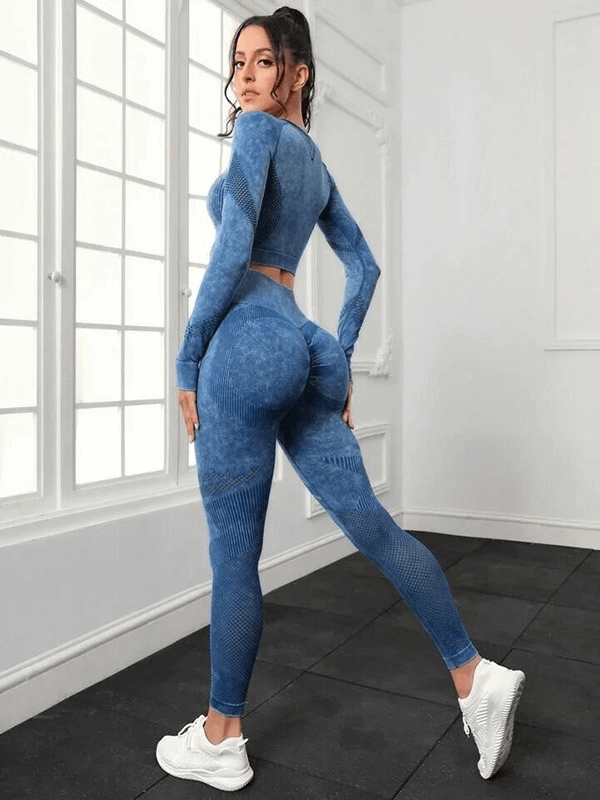 Woman wearing a seamless blue high waist leggings and long sleeved top set in a yoga pose, showcasing fit and eco-friendly fabric.