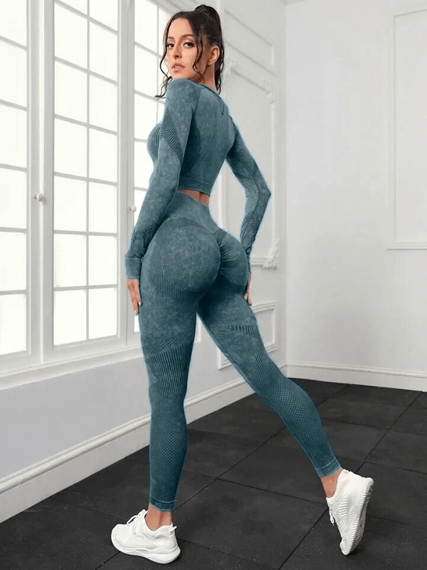 Woman wearing a seamless set of high waist pants and long sleeved top in blue, perfect for yoga, showcasing flexibility and comfort.