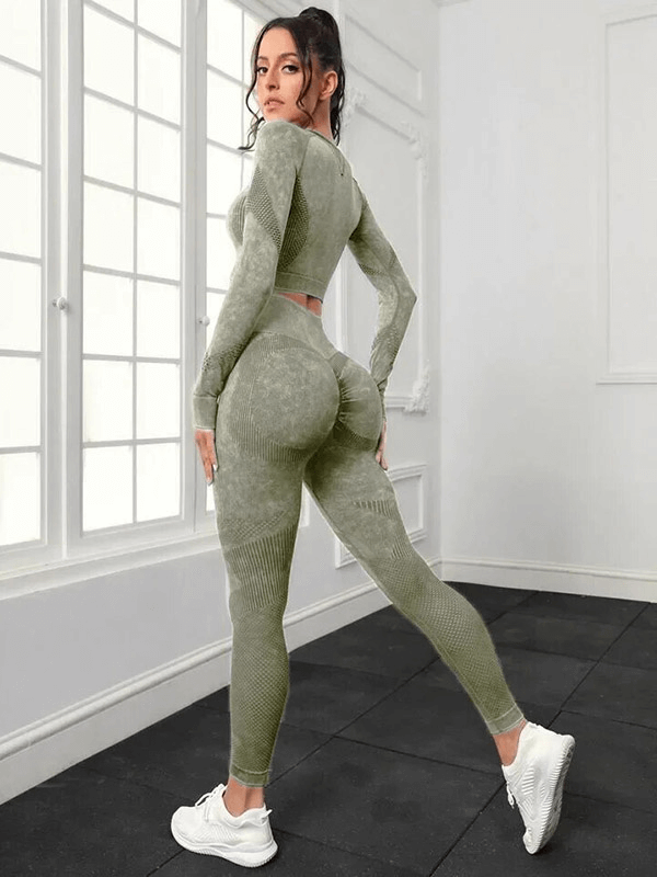 Woman wearing seamless high waist pants and long sleeved top in yoga studio, showcasing flexibility and eco-friendly fabric.