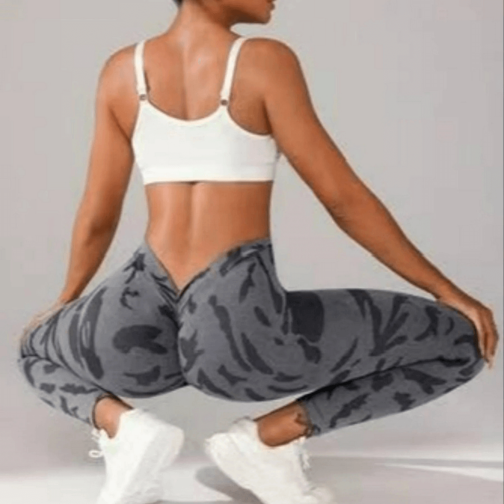 Woman wearing Seamless V-Waist Camo Yoga Leggings with Scrunch - SF4010, ideal for gym, yoga, and running in stylish camo print.