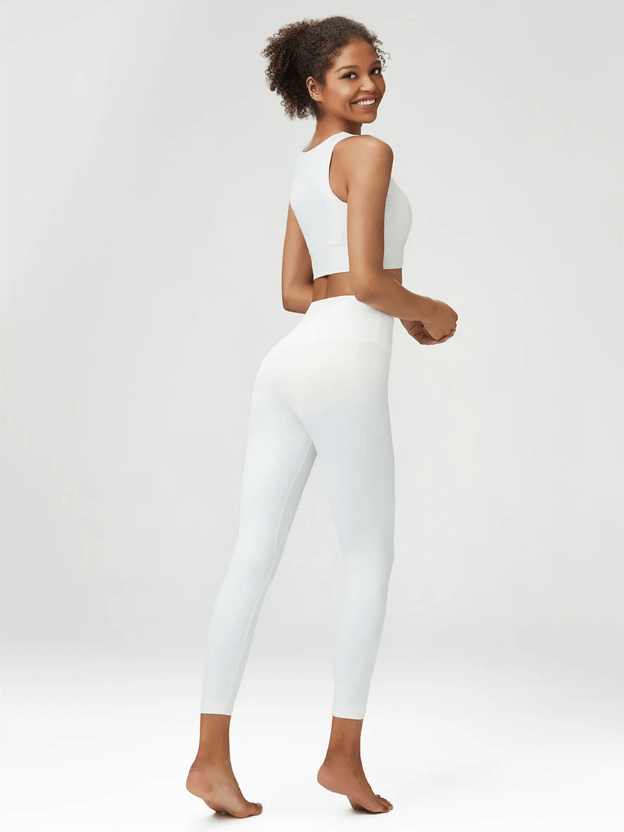 Woman wearing pristine white seamless yoga gear set, demonstrating fitness clothing designed for active women, ideal for yoga and running.