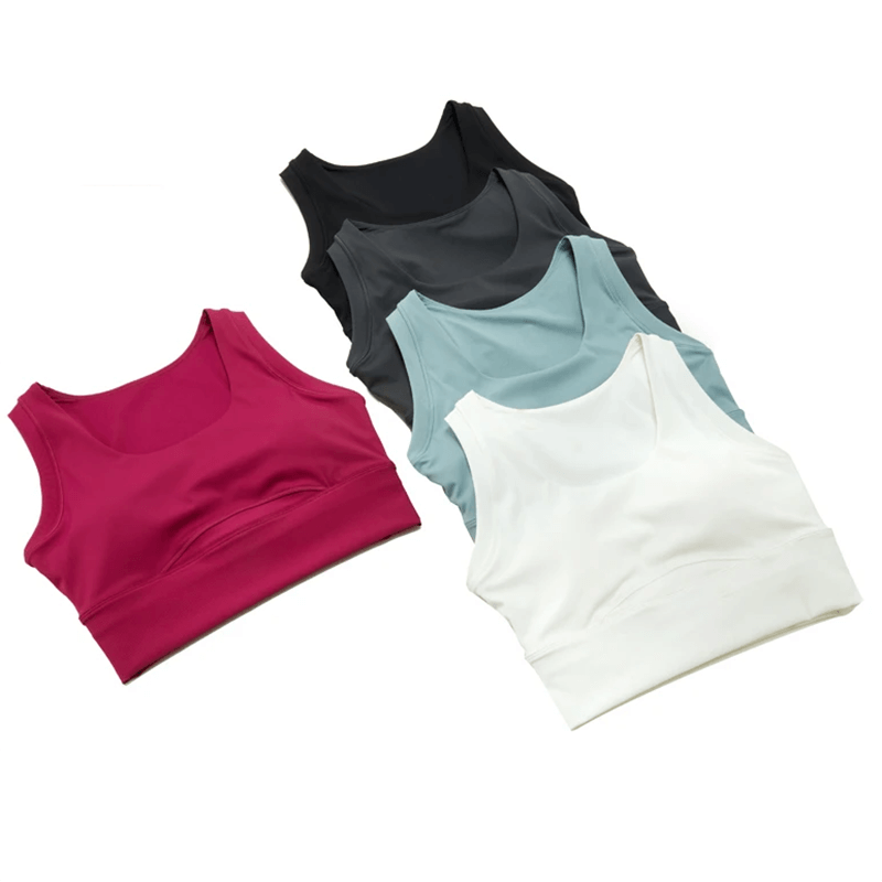 Colorful seamless sports bras in vibrant pink, serene blue, black, and white for active women; perfect for yoga and workouts.