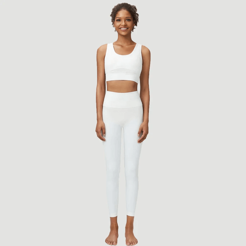 Woman wearing seamless yoga gear set in white - SF2086, featuring a sports bra and leggings for active women. Modern workout attire.