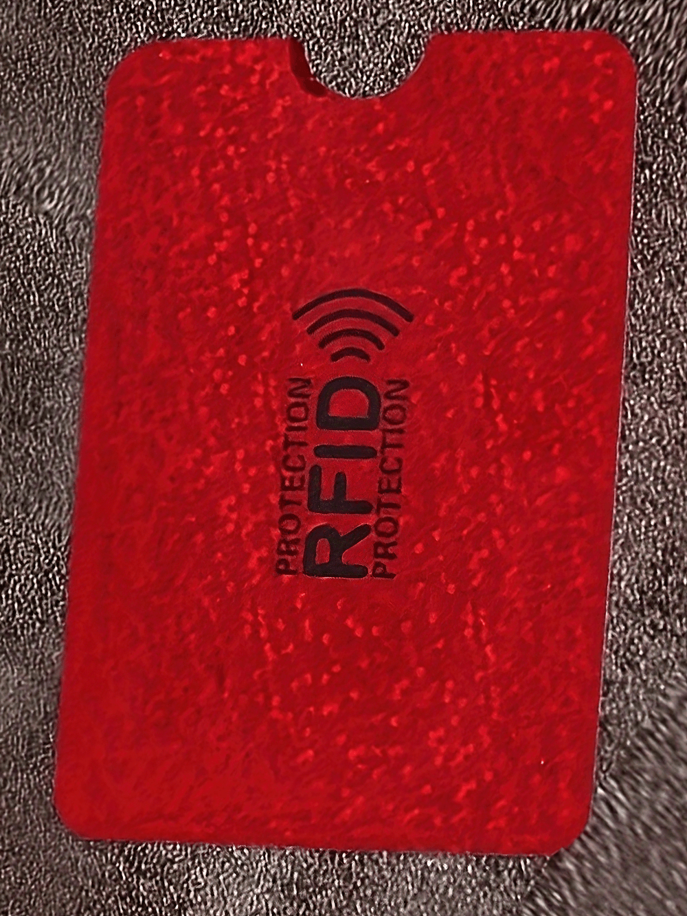 Red RFID blocking card sleeve for secure anti-theft data protection. Slim design, durable plastic, fits easily into wallet.