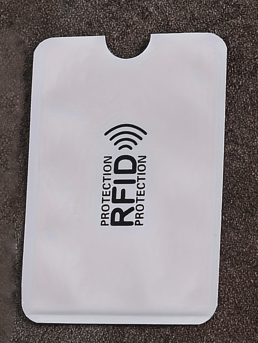 Secure Ultrathin RFID Blocking Card Sleeve SF2676 shown on a dark surface, offering anti-theft protection for credit cards and IDs.