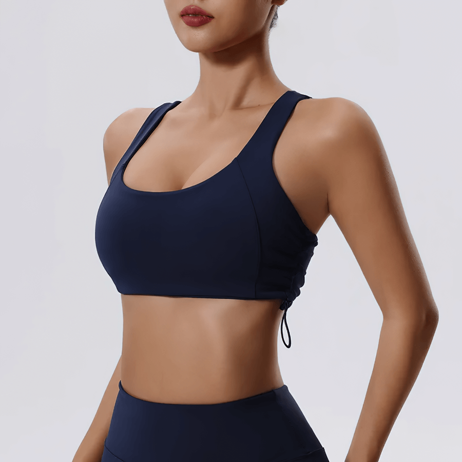 Woman wearing a sexy adjustable sports bra for fitness and yoga with a stylish push-up and breathable design.