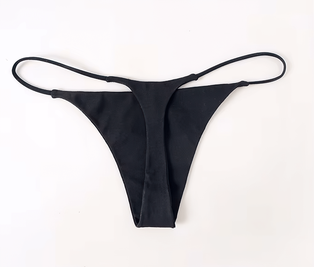 Black low-rise cotton thong bikini for women, featuring a sexy T-back and seamless G-string design for stylish minimal visibility.