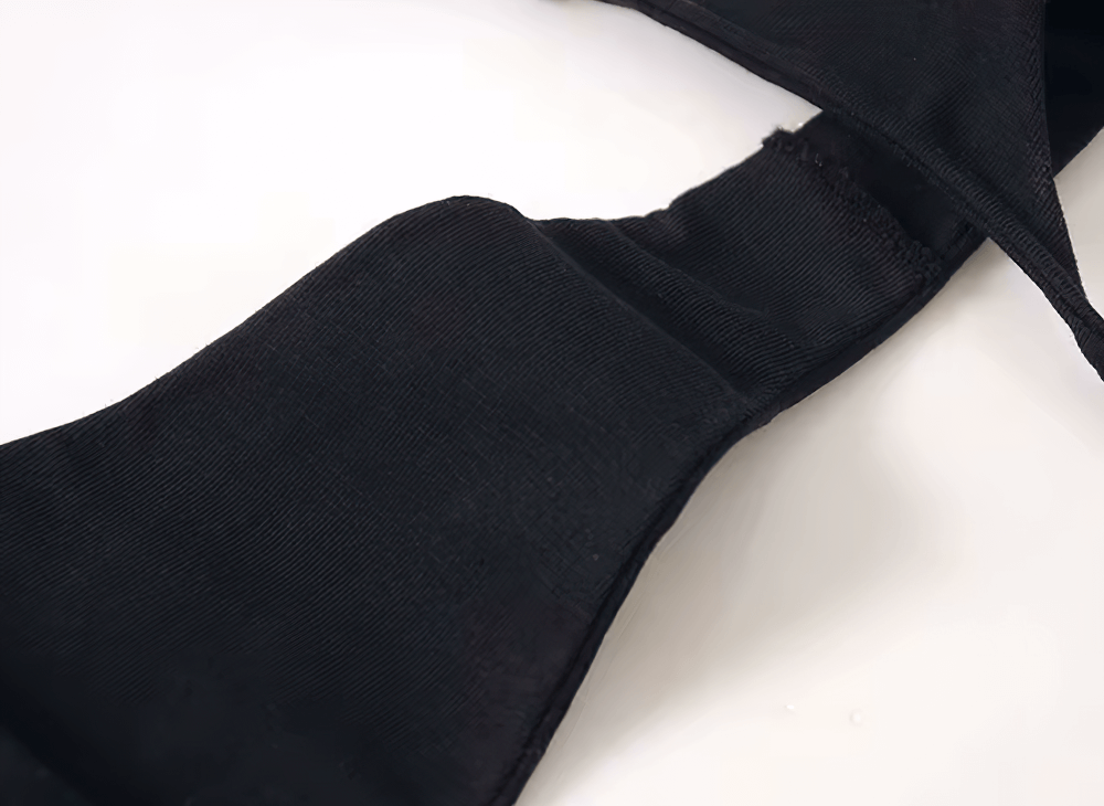 Close-up of black cotton low-rise thong bikini for women, featuring a stylish T-back and seamless G-string design for minimal visibility.