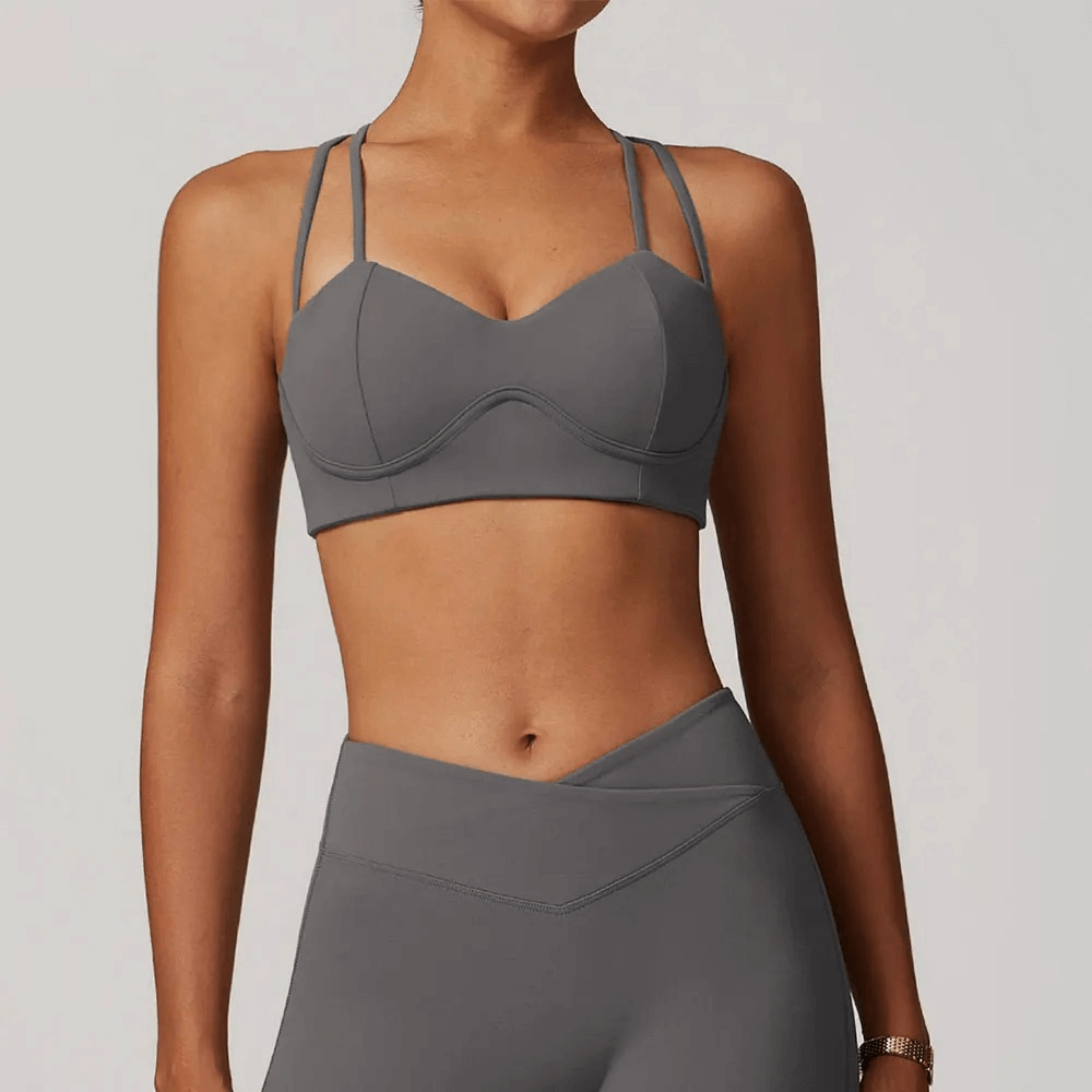 Woman wearing sexy criss-cross strap sports bra SF2459, high support, breathable and quick-dry for running, yoga, and workouts.