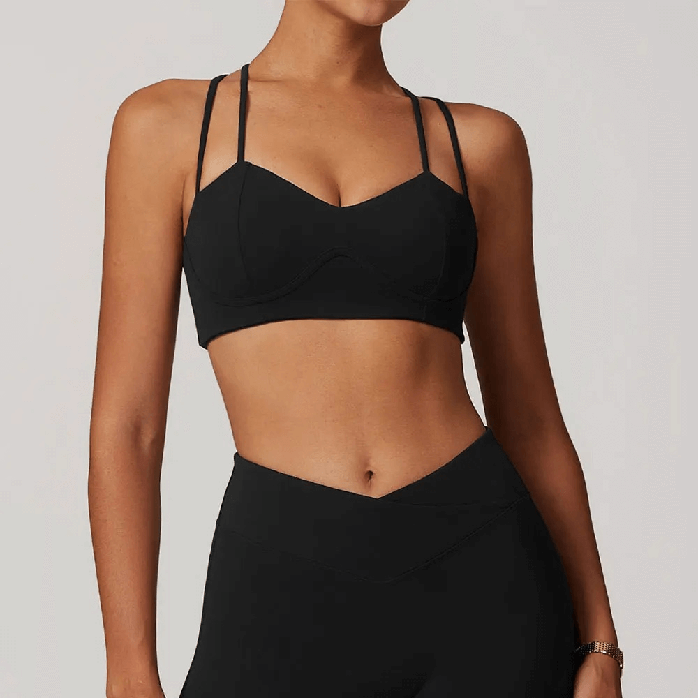 Women's black criss-cross strap sports bra offering high support for activewear, ideal for running, yoga, and fitness routines.